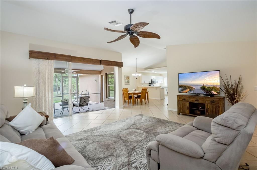 2910 2nd Street Northeast Naples, FL 34120 - Photo 8 of 36 a living room with furniture a fireplace and a flat screen tv
