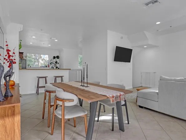 a view of a dining room with furniture and a flat screen tv