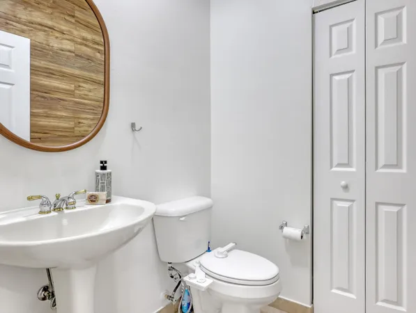 a bathroom with a sink a mirror and a toilet