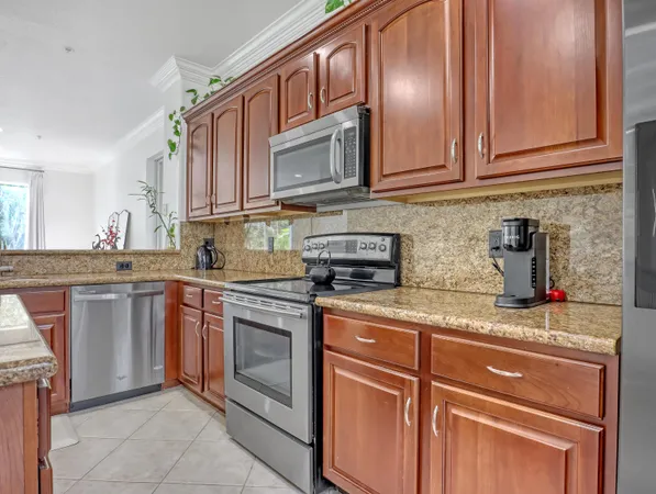 a kitchen with stainless steel appliances granite countertop a sink stove and cabinets