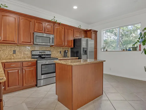 a kitchen with stainless steel appliances granite countertop a refrigerator stove a sink and dishwasher
