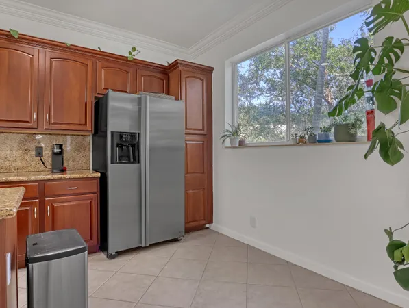 a kitchen with stainless steel appliances granite countertop a refrigerator and a stove