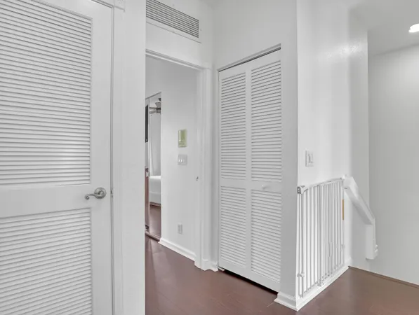 a bedroom with a bed and a flat tv screen on dresser