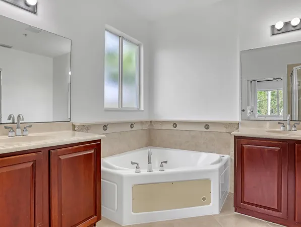 a bathroom with a granite countertop sink a toilet and a mirror