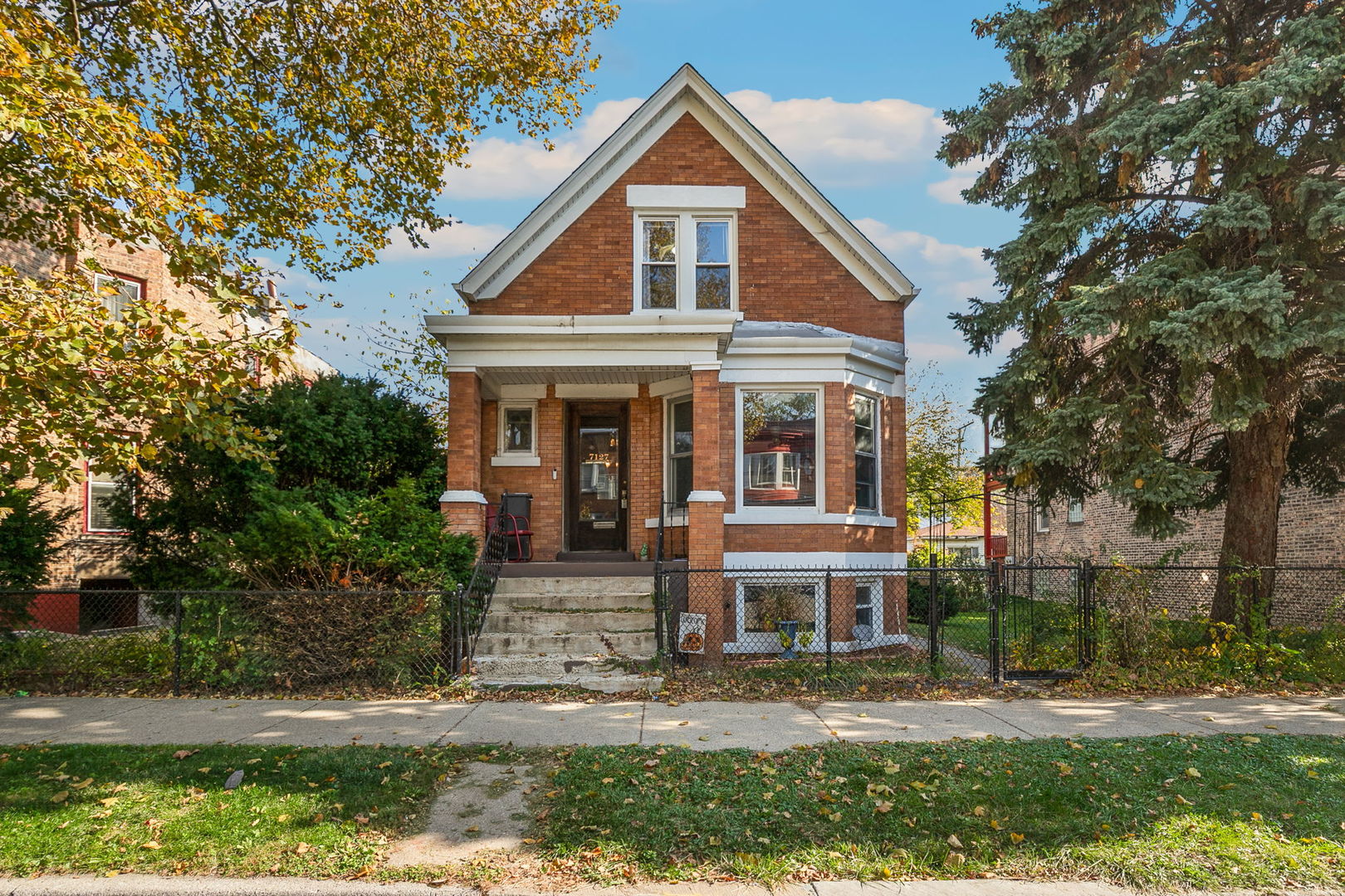 7127 South St Lawrence Avenue Chicago, IL 60619 - Photo 1 of 26 front view of house with a yard