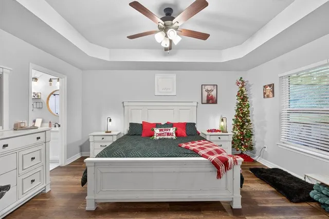 a large white room with a mirror and a bath tub