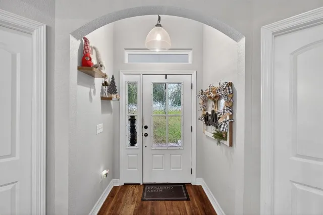 a living room with furniture a flat screen tv and a table