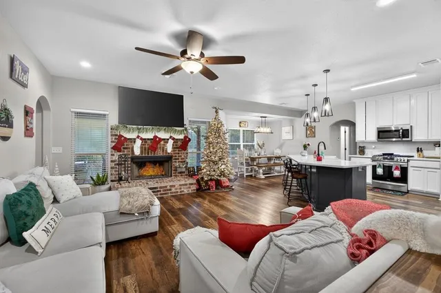 a living room with furniture and a chandelier