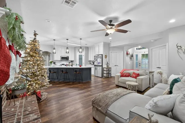 a kitchen with kitchen island a sink and a chandelier