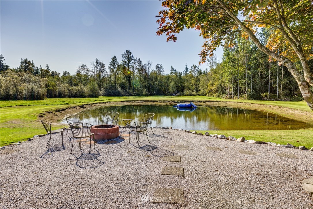 3141 Loomis Trail Road Custer, WA 98240 - Photo 7 of 25 a view of a lake with a yard and a large tree