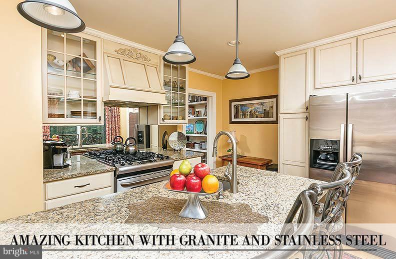 505 Sussex Road Towson, MD 21286 - Photo 2 of 30 a kitchen with stainless steel appliances granite countertop a stove a refrigerator and a dining table with wooden floor
