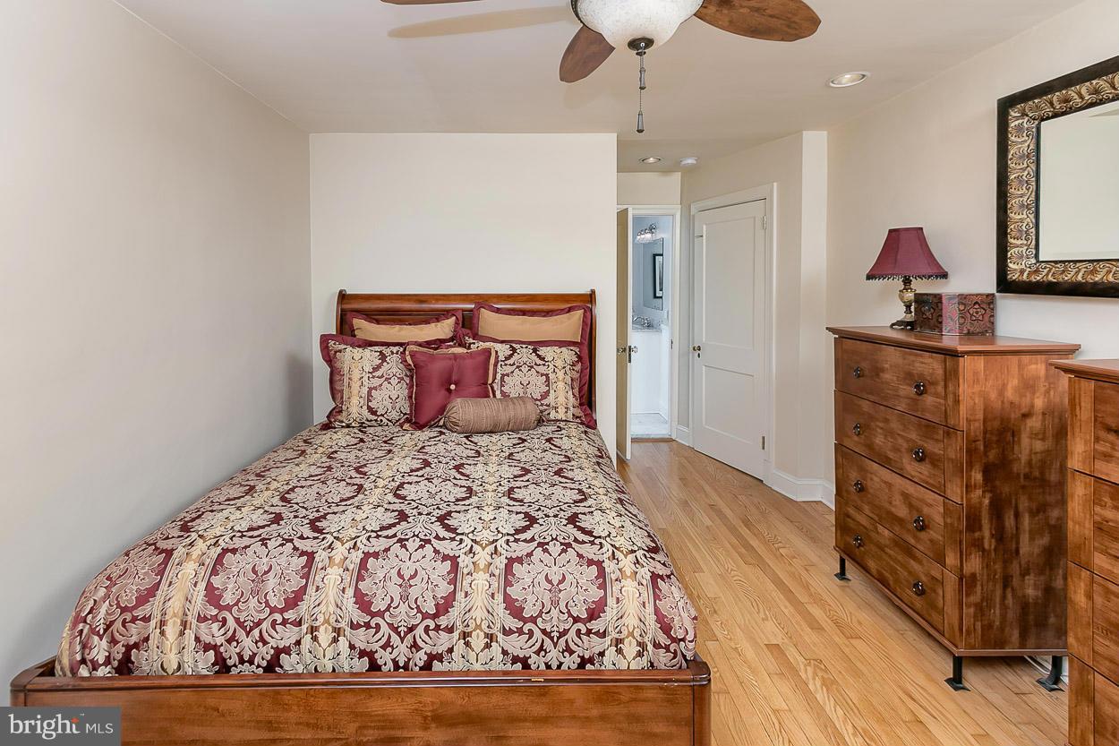 505 Sussex Road Towson, MD 21286 - Photo 17 of 30 a bedroom with a bed and wooden floor