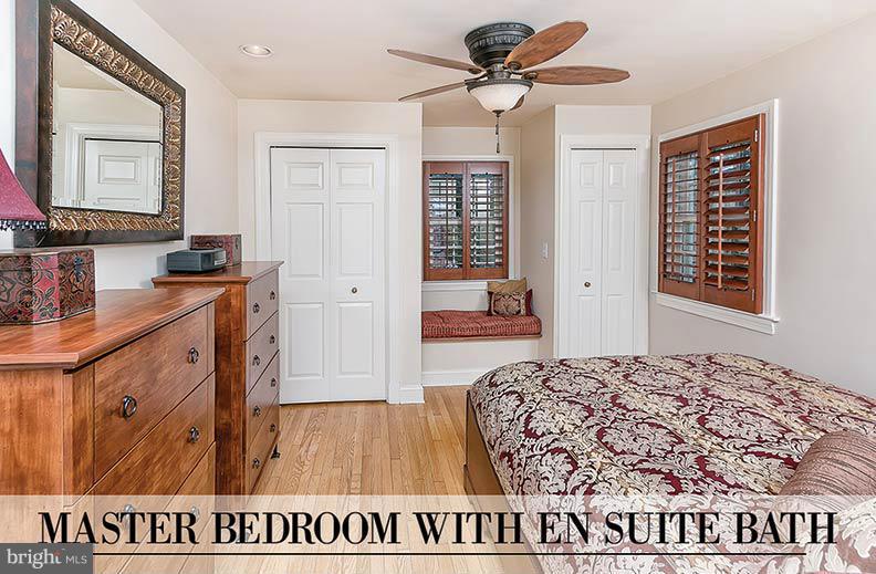 505 Sussex Road Towson, MD 21286 - Photo 3 of 30 a bedroom with a bed and wooden floor