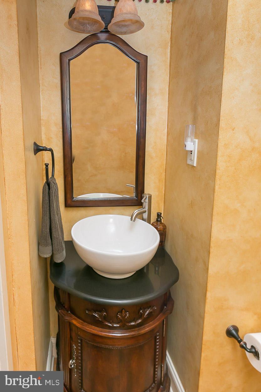 505 Sussex Road Towson, MD 21286 - Photo 22 of 30 a bathroom with a sink and a mirror