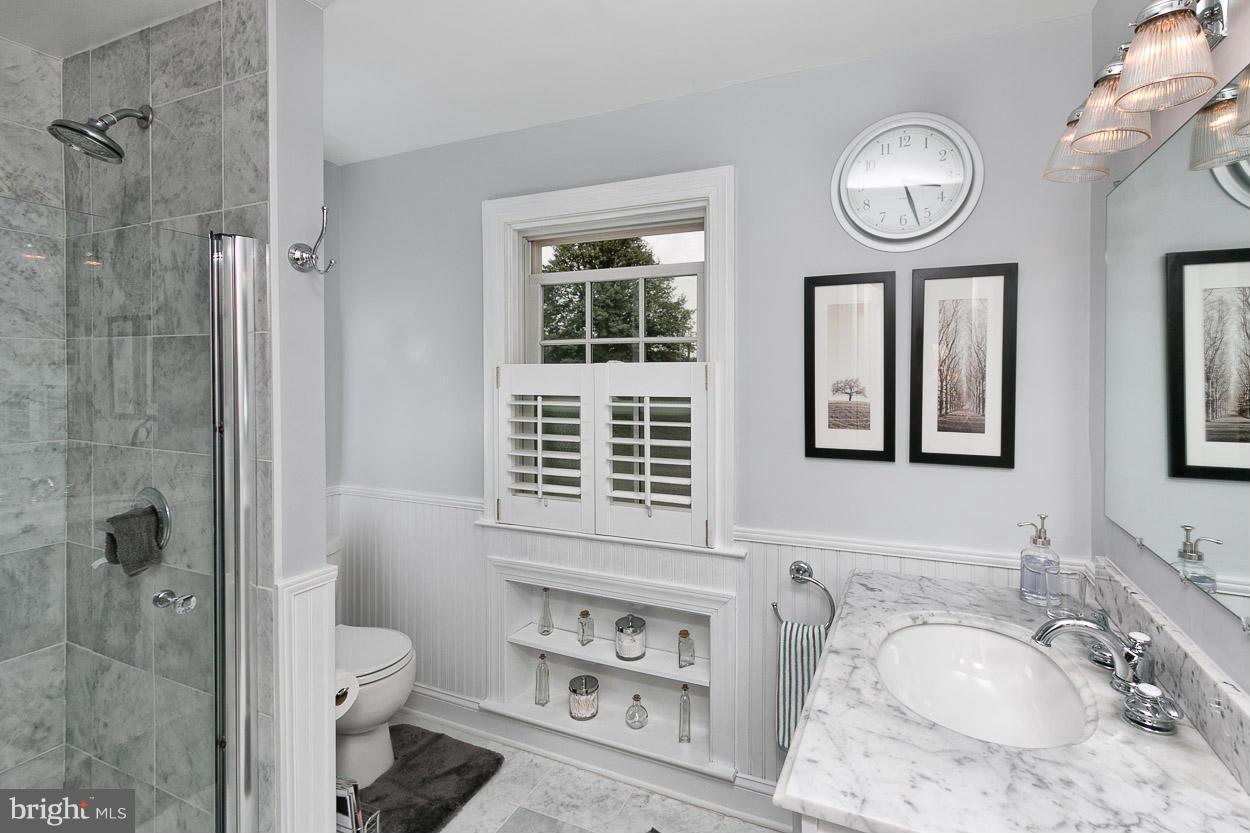 505 Sussex Road Towson, MD 21286 - Photo 24 of 30 a bathroom with a granite countertop sink toilet a mirror and shower