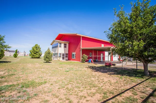 a kitchen with stainless steel appliances granite countertop a stove top oven a dining table and chairs with wooden floor