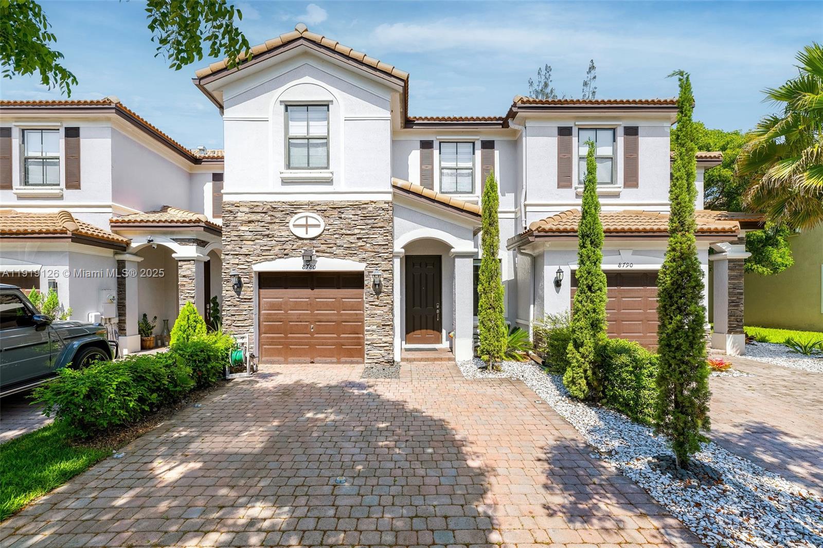 8780 Northwest 116th Path Doral, FL 33178 - Photo 1 of 32 a front view of a house with garden