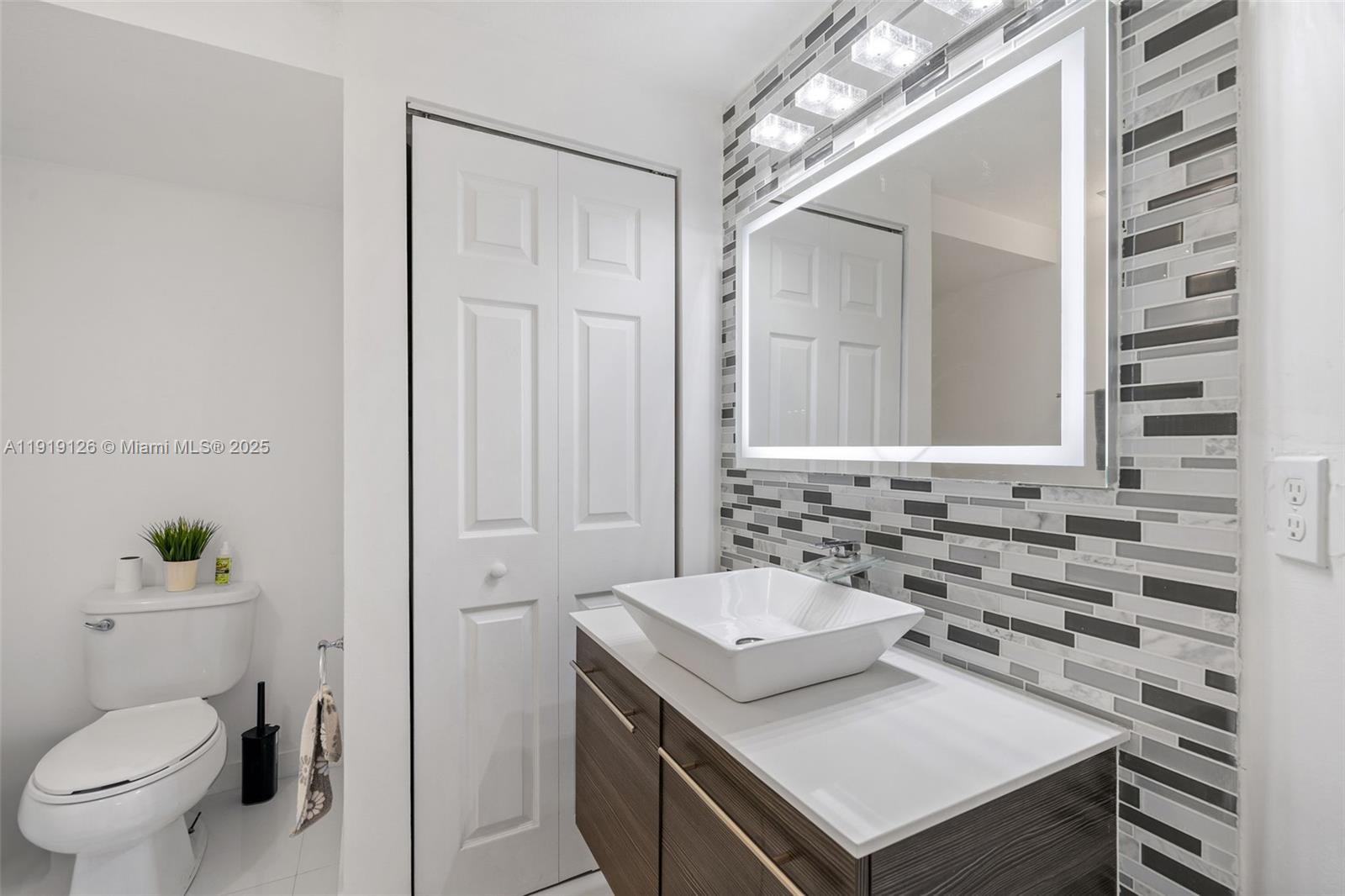 8780 Northwest 116th Path Doral, FL 33178 - Photo 12 of 32 a bathroom with a sink toilet and shower