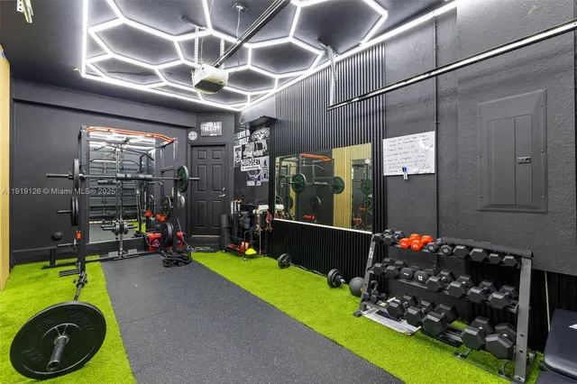 a kitchen with stainless steel appliances kitchen island granite countertop a stove top oven a sink a dining table and chairs with wooden floor