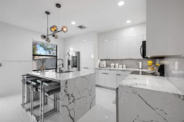 a kitchen with a sink stove and refrigerator