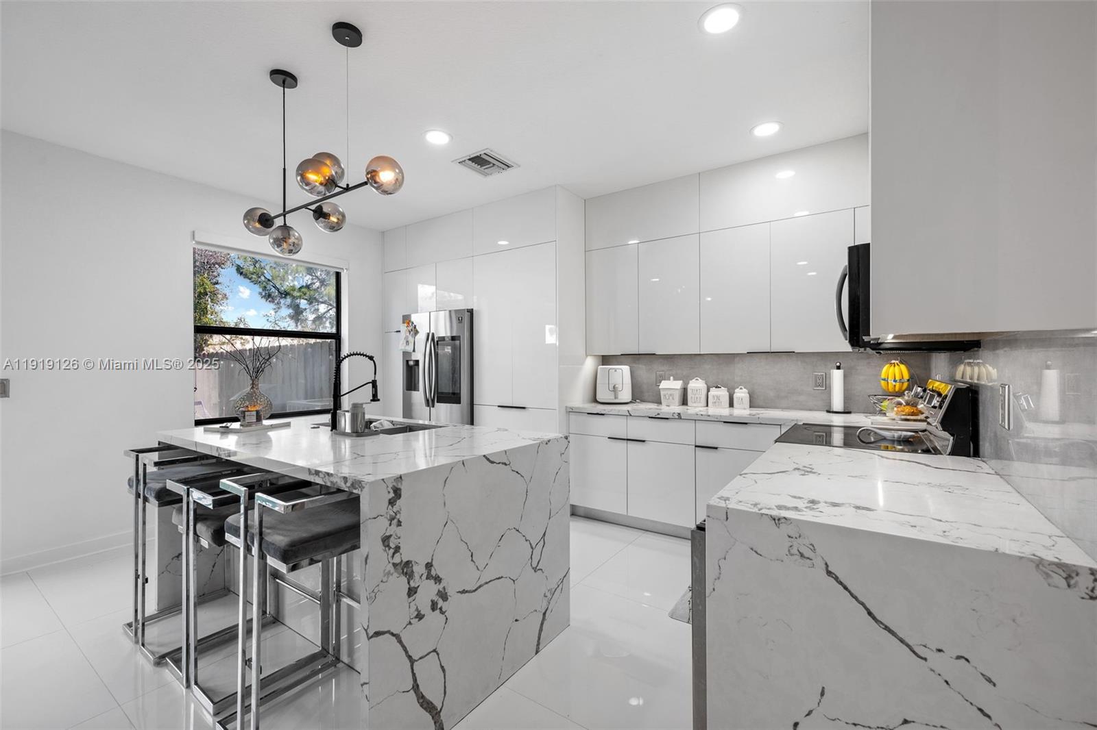 8780 Northwest 116th Path Doral, FL 33178 - Photo 17 of 32 a kitchen that has a lot of cabinets in it and appliances