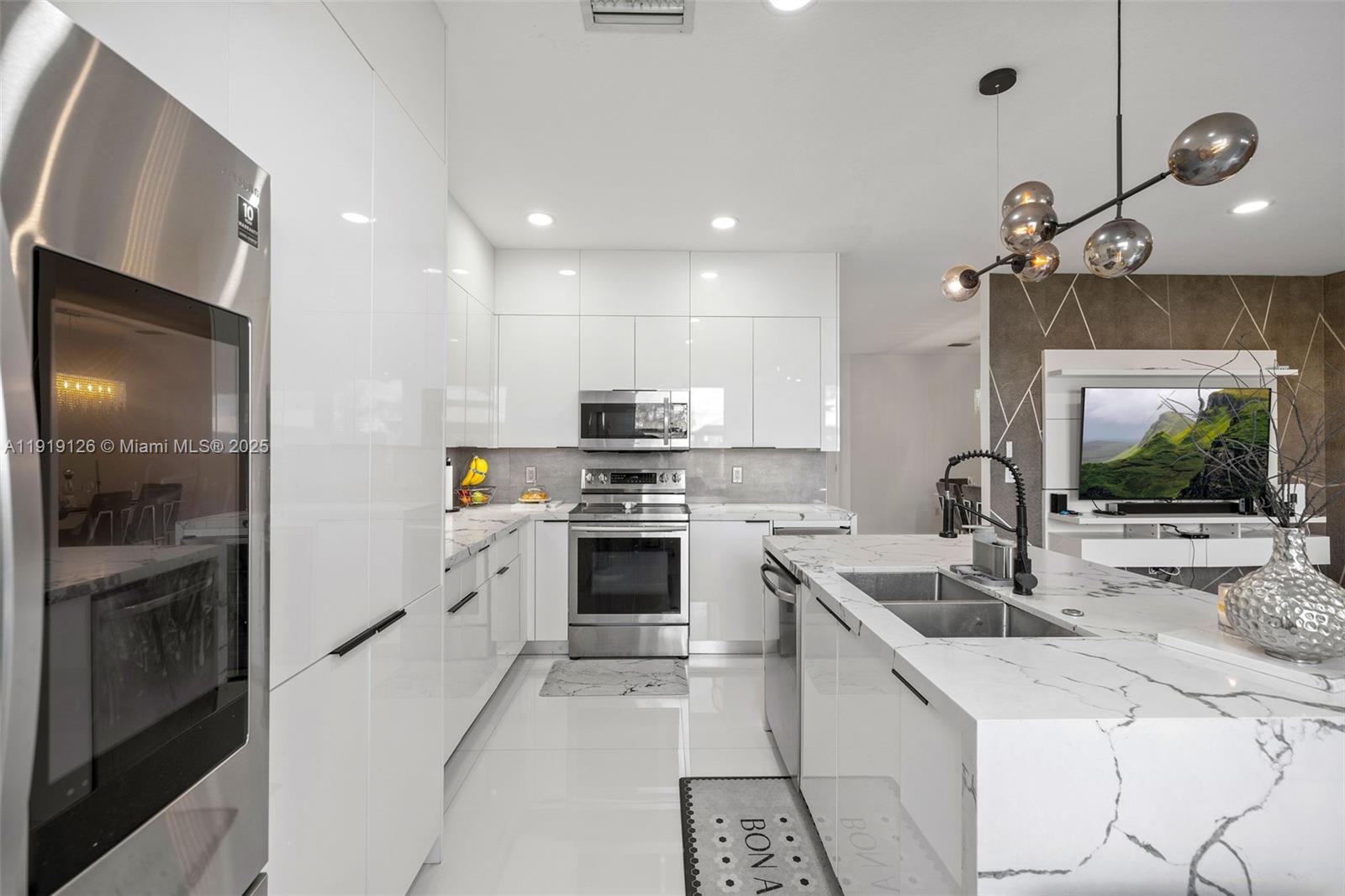 8780 Northwest 116th Path Doral, FL 33178 - Photo 18 of 32 a kitchen with a sink stove and refrigerator