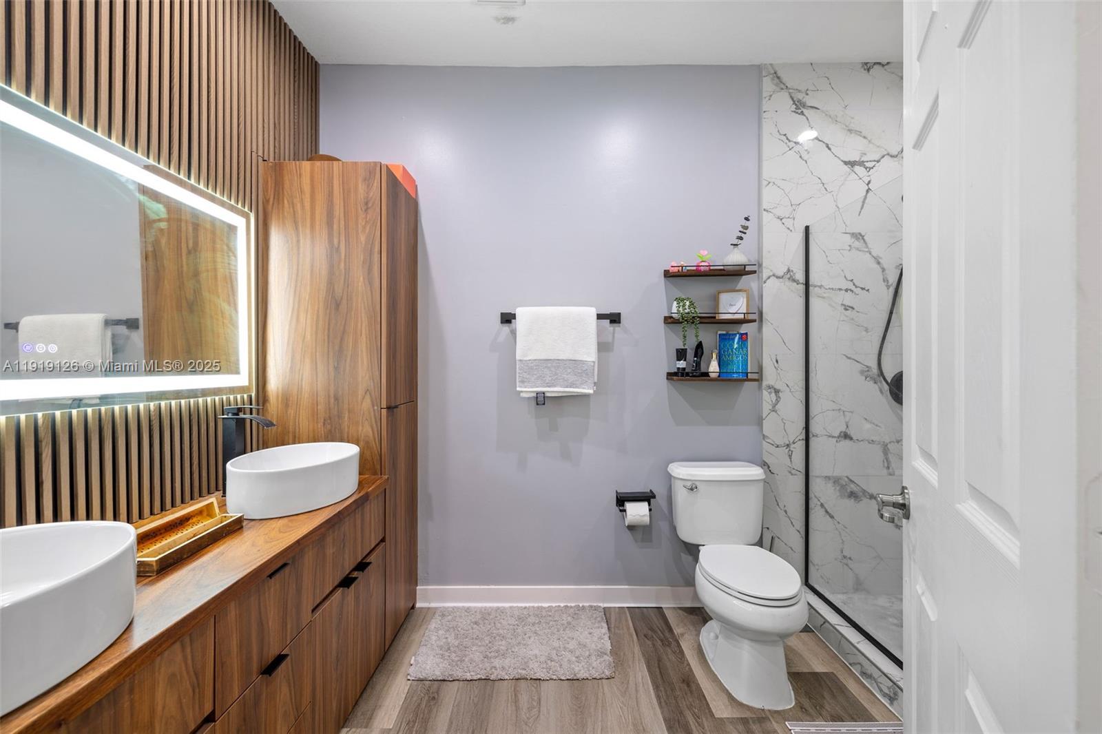 8780 Northwest 116th Path Doral, FL 33178 - Photo 24 of 32 a bathroom with a toilet a sink and shower curtain