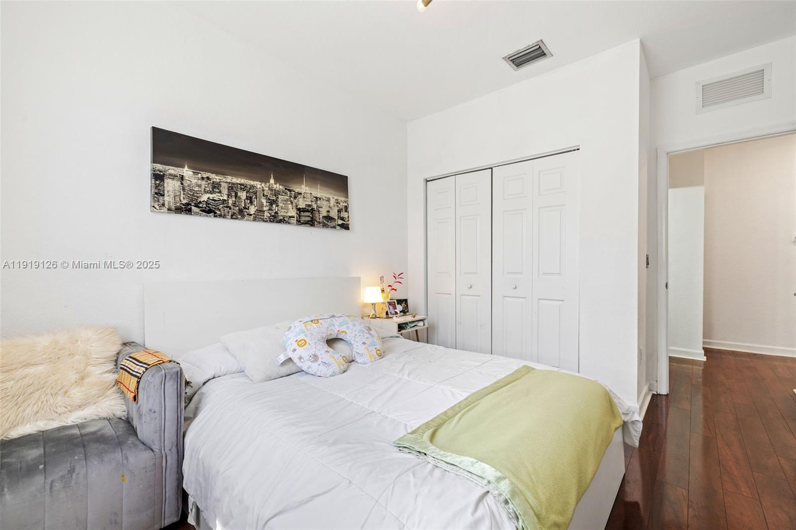 8780 Northwest 116th Path Doral, FL 33178 - Photo 25 of 32 a bedroom with a bed and wooden floor