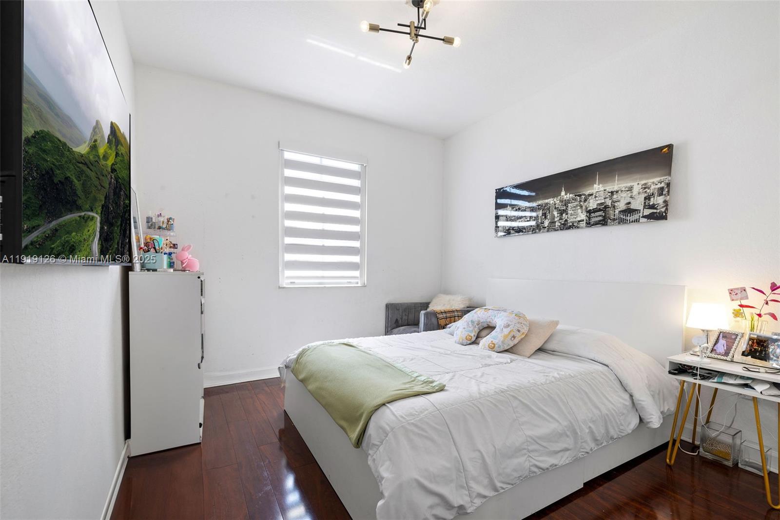 8780 Northwest 116th Path Doral, FL 33178 - Photo 26 of 32 a bedroom with a bed and a potted plant