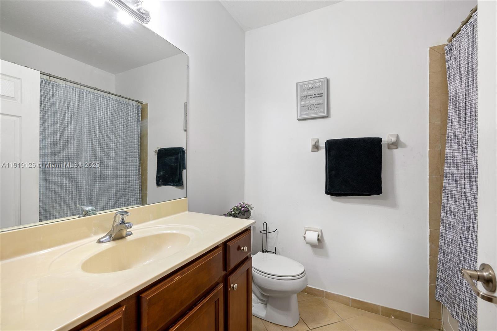 8780 Northwest 116th Path Doral, FL 33178 - Photo 27 of 32 a bathroom with a sink a toilet and shower