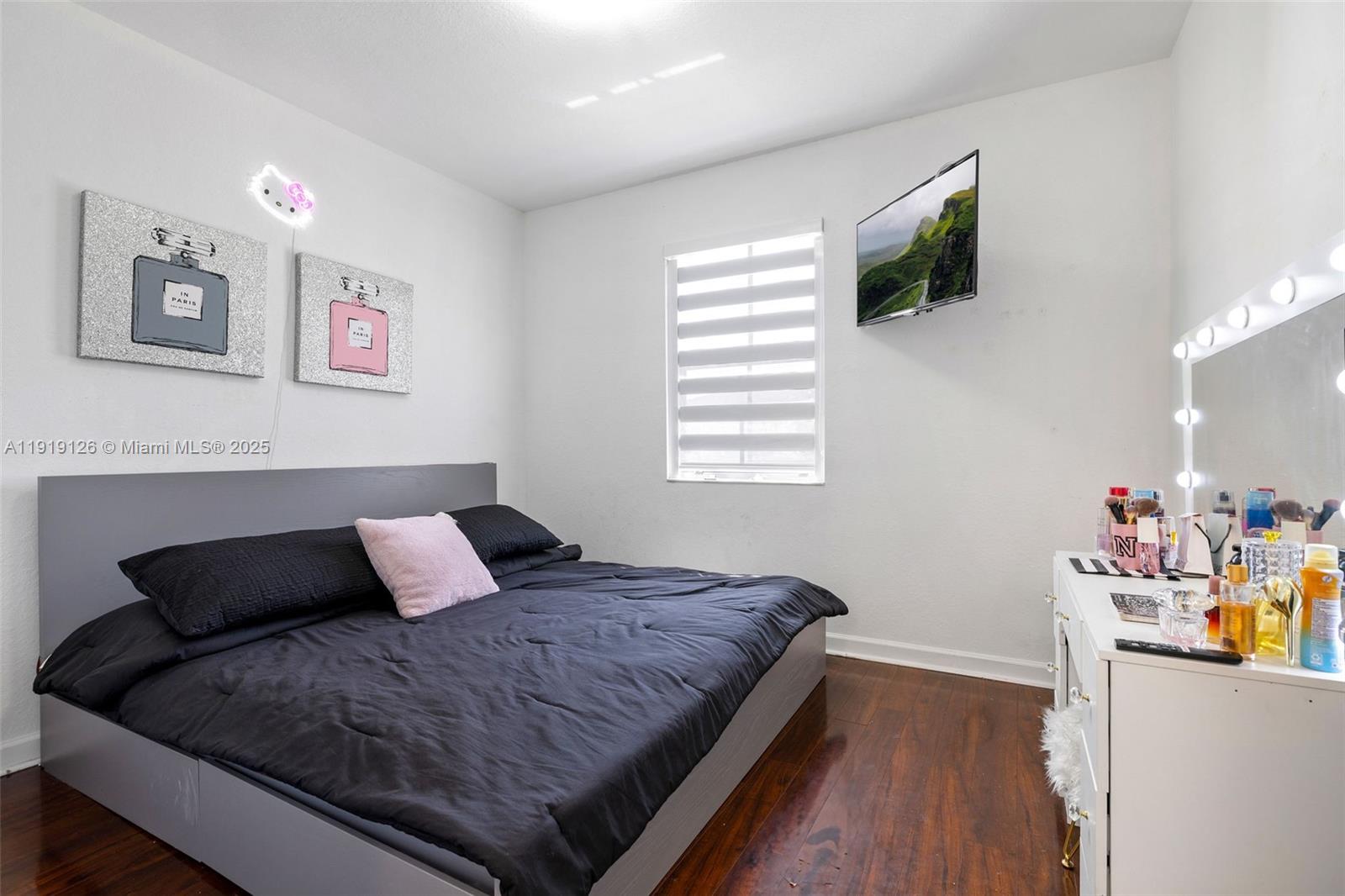 8780 Northwest 116th Path Doral, FL 33178 - Photo 30 of 32 a bedroom with a bed and wooden floor