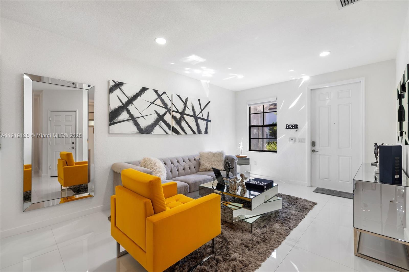 8780 Northwest 116th Path Doral, FL 33178 - Photo 8 of 32 a living room with furniture and a flat screen tv