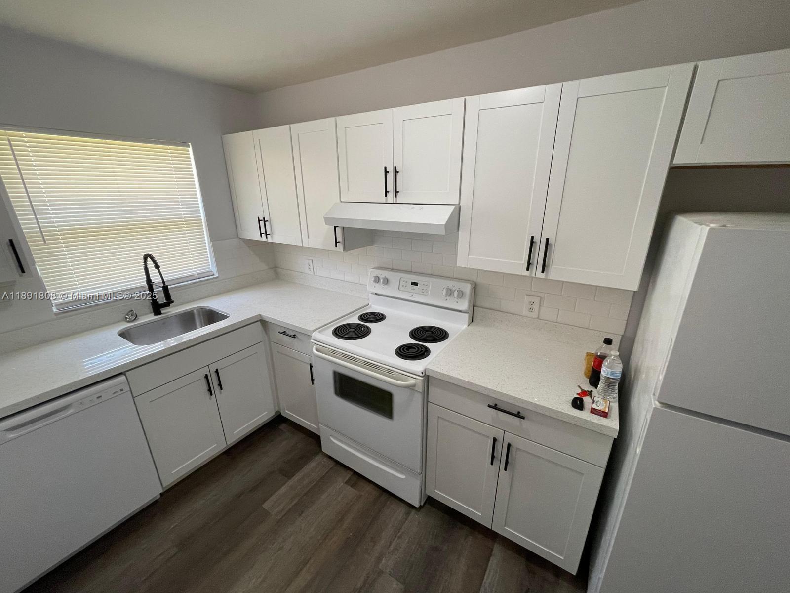 5040 Sanctuary Way, Unit B West Palm Beach, FL 33417 - Photo 1 of 10 a white kitchen with sink and white appliances