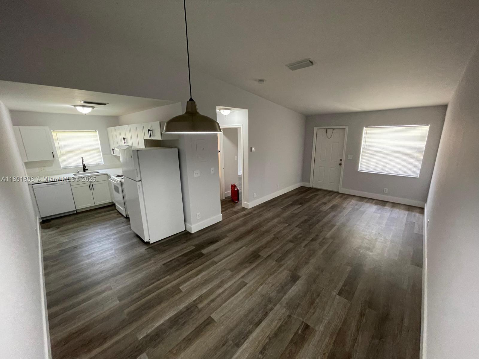 5040 Sanctuary Way, Unit B West Palm Beach, FL 33417 - Photo 4 of 10 a kitchen with cabinets and wooden floor
