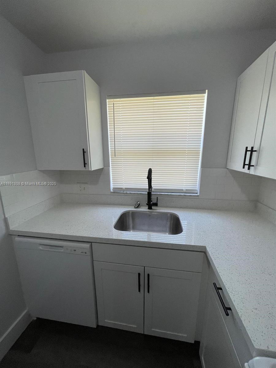 5040 Sanctuary Way, Unit B West Palm Beach, FL 33417 - Photo 5 of 10 a kitchen with a sink and a window