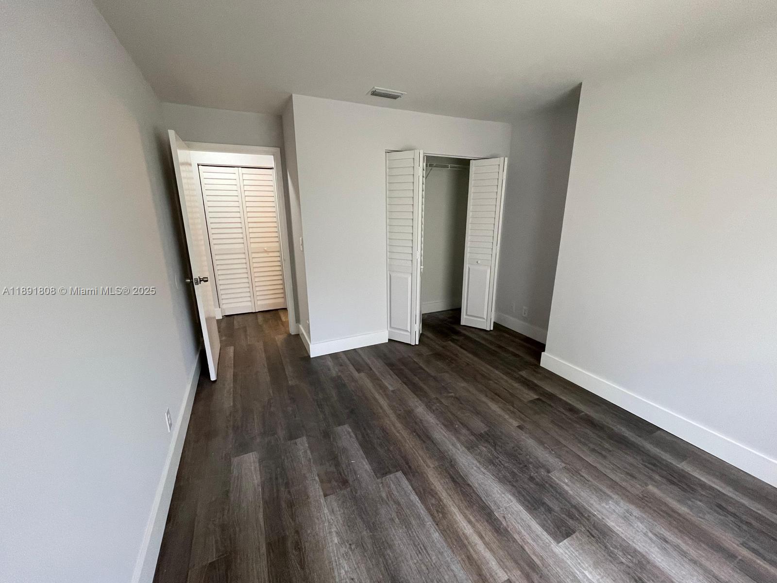 5040 Sanctuary Way, Unit B West Palm Beach, FL 33417 - Photo 8 of 10 a view of a room with wooden floor and staircase