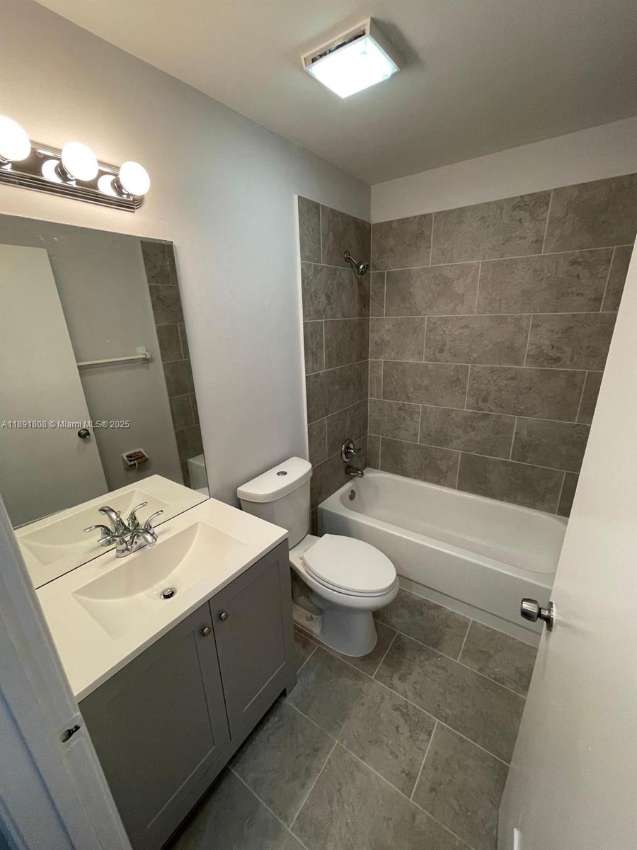 5040 Sanctuary Way, Unit B West Palm Beach, FL 33417 - Photo 10 of 10 a bathroom with a sink a toilet and shower