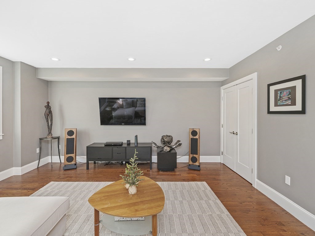 198 California Street, Unit 3 Newton, MA 02458 - Photo 13 of 34 a living room with furniture and a wooden floor
