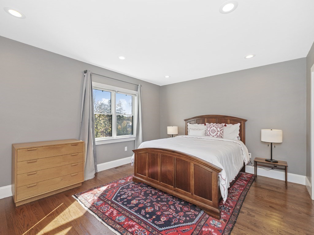 198 California Street, Unit 3 Newton, MA 02458 - Photo 18 of 34 a bedroom with a bed and a window