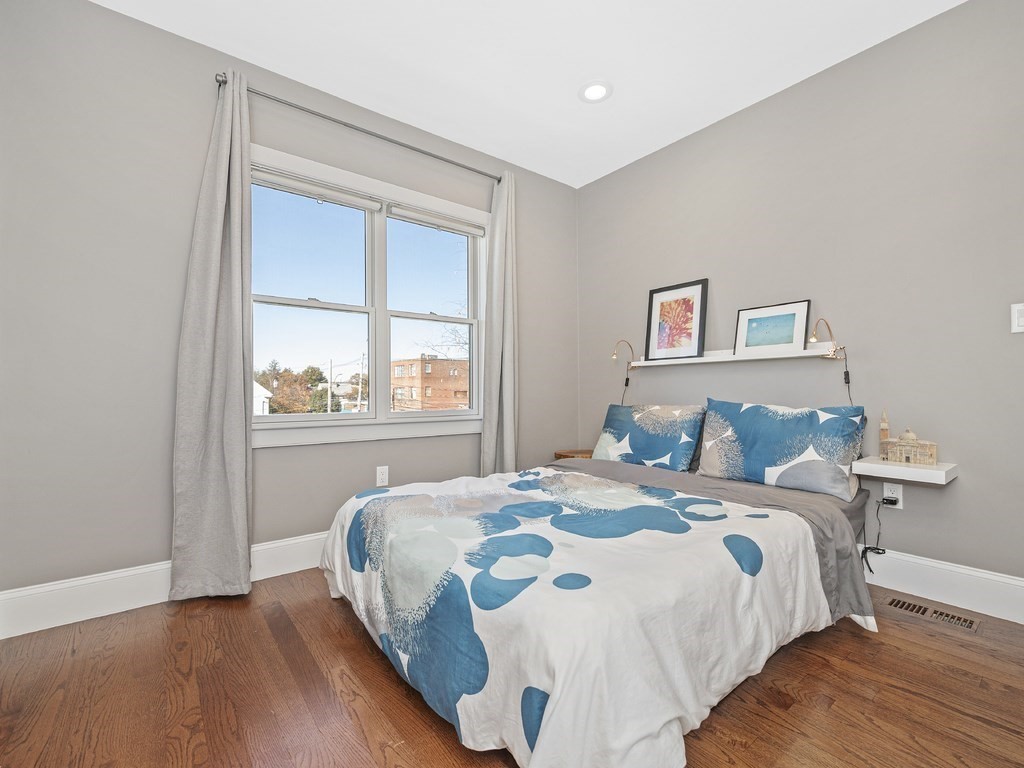 198 California Street, Unit 3 Newton, MA 02458 - Photo 20 of 34 a bedroom with a bed and a window