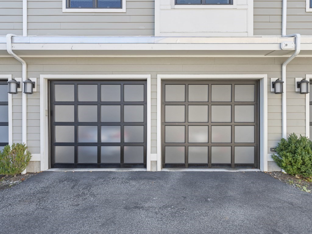 198 California Street, Unit 3 Newton, MA 02458 - Photo 30 of 34 a view of a house with a large window and a garage