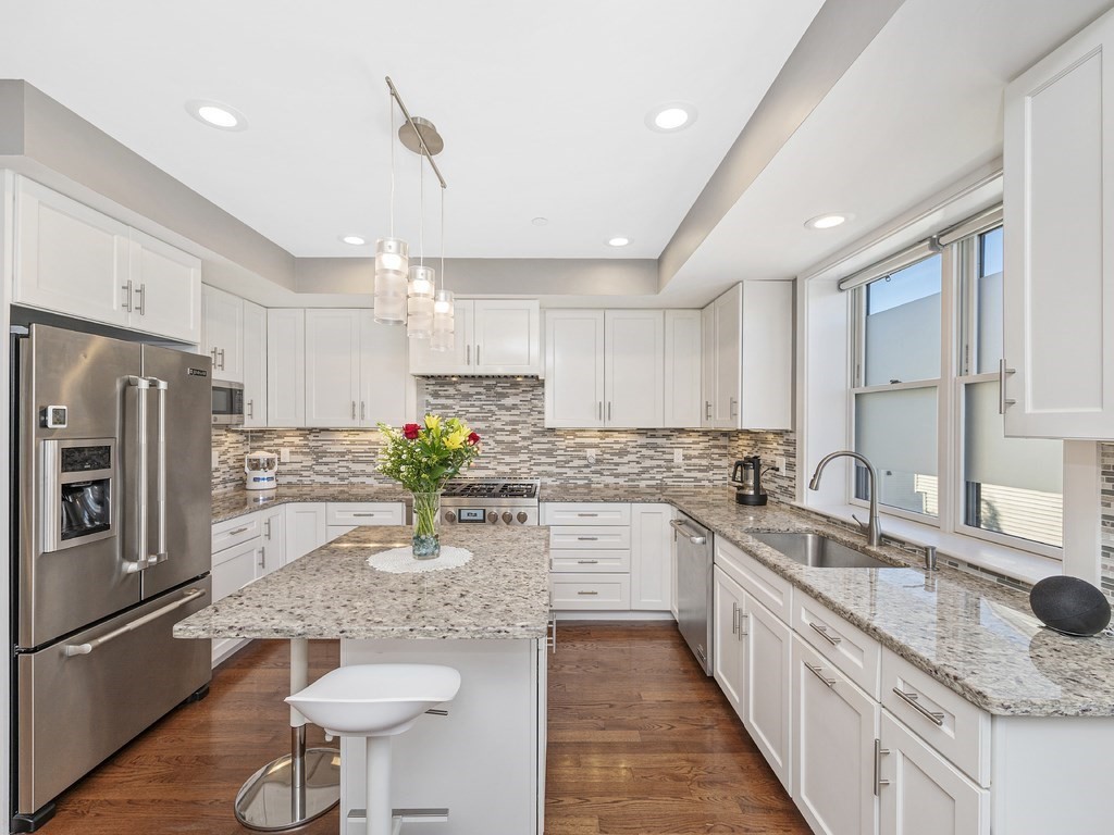 198 California Street, Unit 3 Newton, MA 02458 - Photo 4 of 34 a kitchen with stainless steel appliances granite countertop a sink refrigerator and cabinets