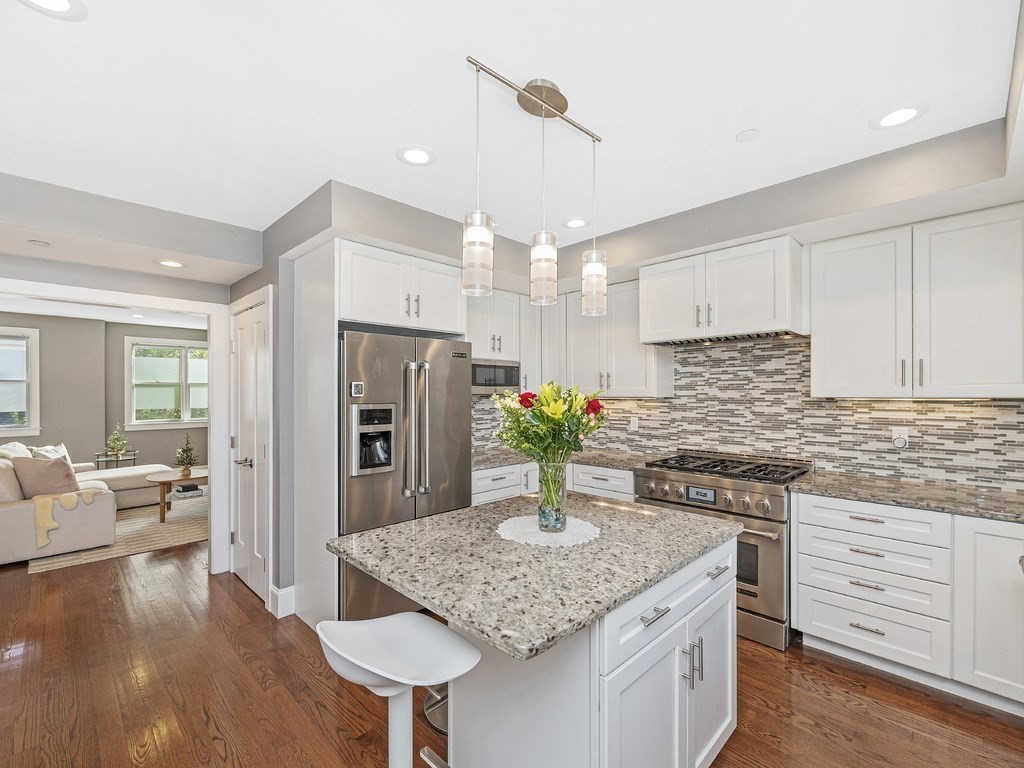 198 California Street, Unit 3 Newton, MA 02458 - Photo 5 of 34 a kitchen with kitchen island stainless steel appliances a sink stove and refrigerator