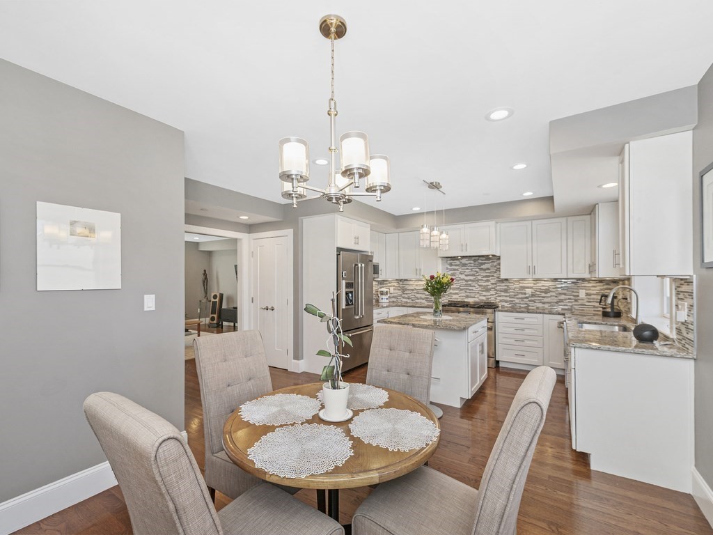 198 California Street, Unit 3 Newton, MA 02458 - Photo 6 of 34 a view of a dining room with furniture a chandelier and wooden floor