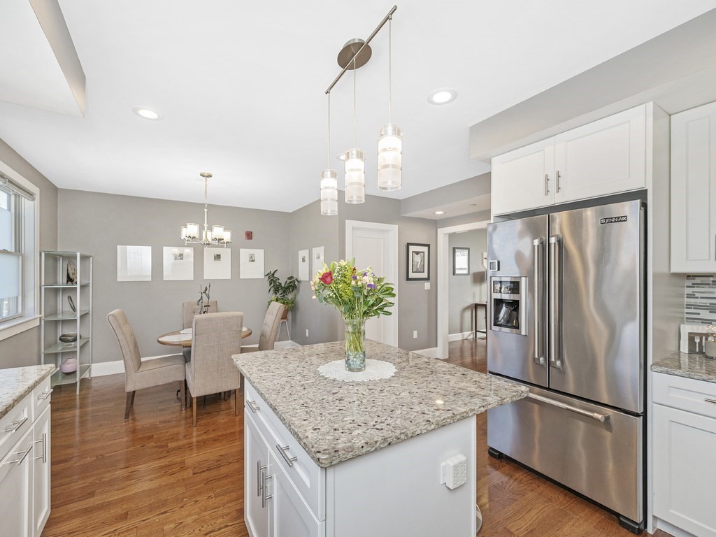 198 California Street, Unit 3 Newton, MA 02458 - Photo 7 of 34 a kitchen with stainless steel appliances granite countertop a refrigerator and a view of living room