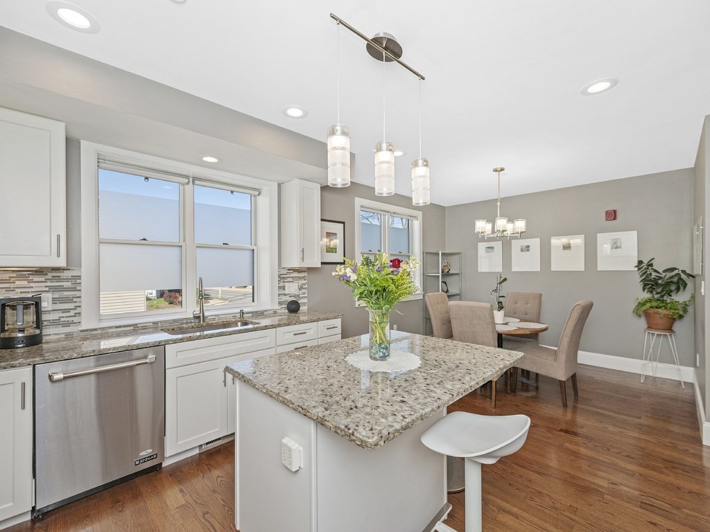 198 California Street, Unit 3 Newton, MA 02458 - Photo 8 of 34 a kitchen with a dining table chairs and wooden floor