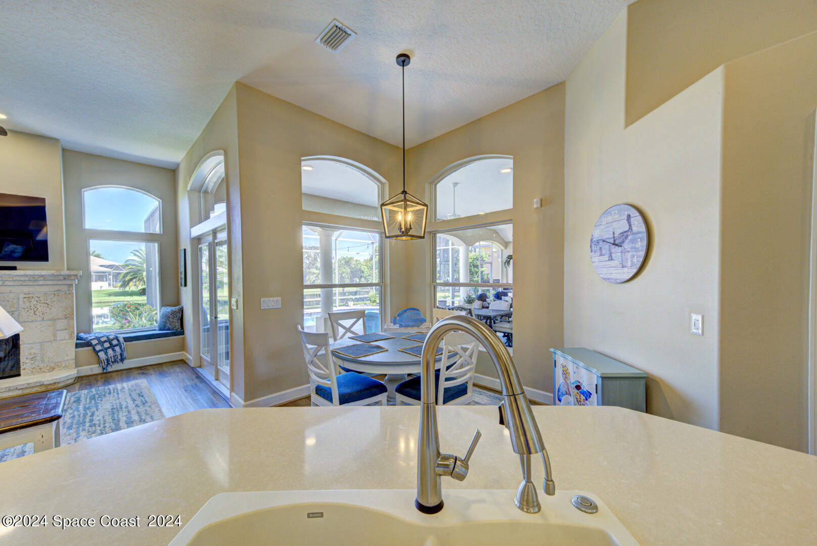 4070 Stoney Point Road Melbourne, FL 32940 - Photo 19 of 75 a living room with furniture a large window and a chandelier