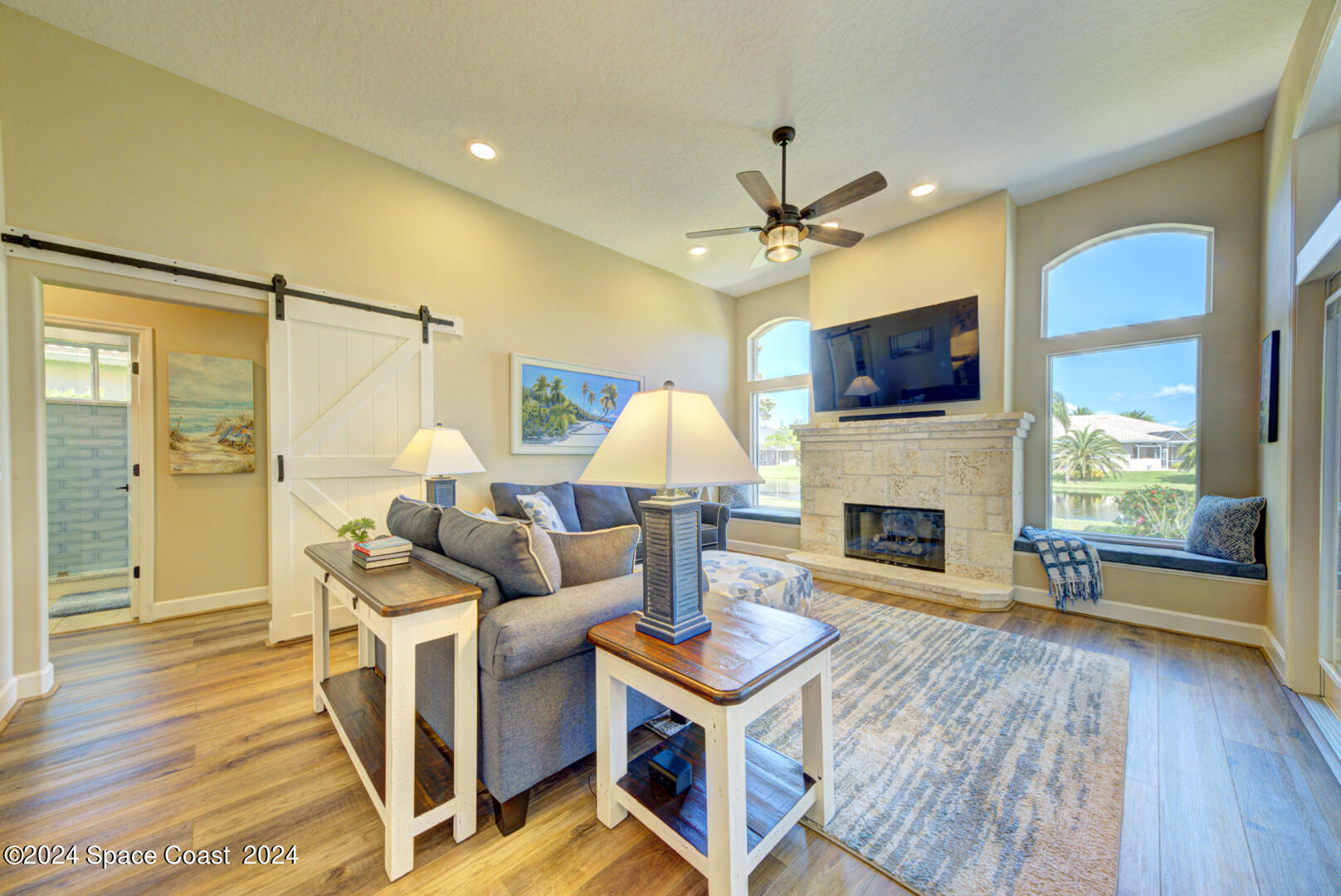 4070 Stoney Point Road Melbourne, FL 32940 - Photo 23 of 75 a living room with furniture a fireplace and a flat screen tv