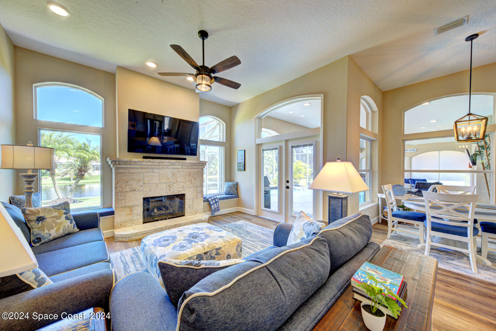 4070 Stoney Point Road Melbourne, FL 32940 - Photo 24 of 75 a living room with furniture a fireplace and a flat screen tv