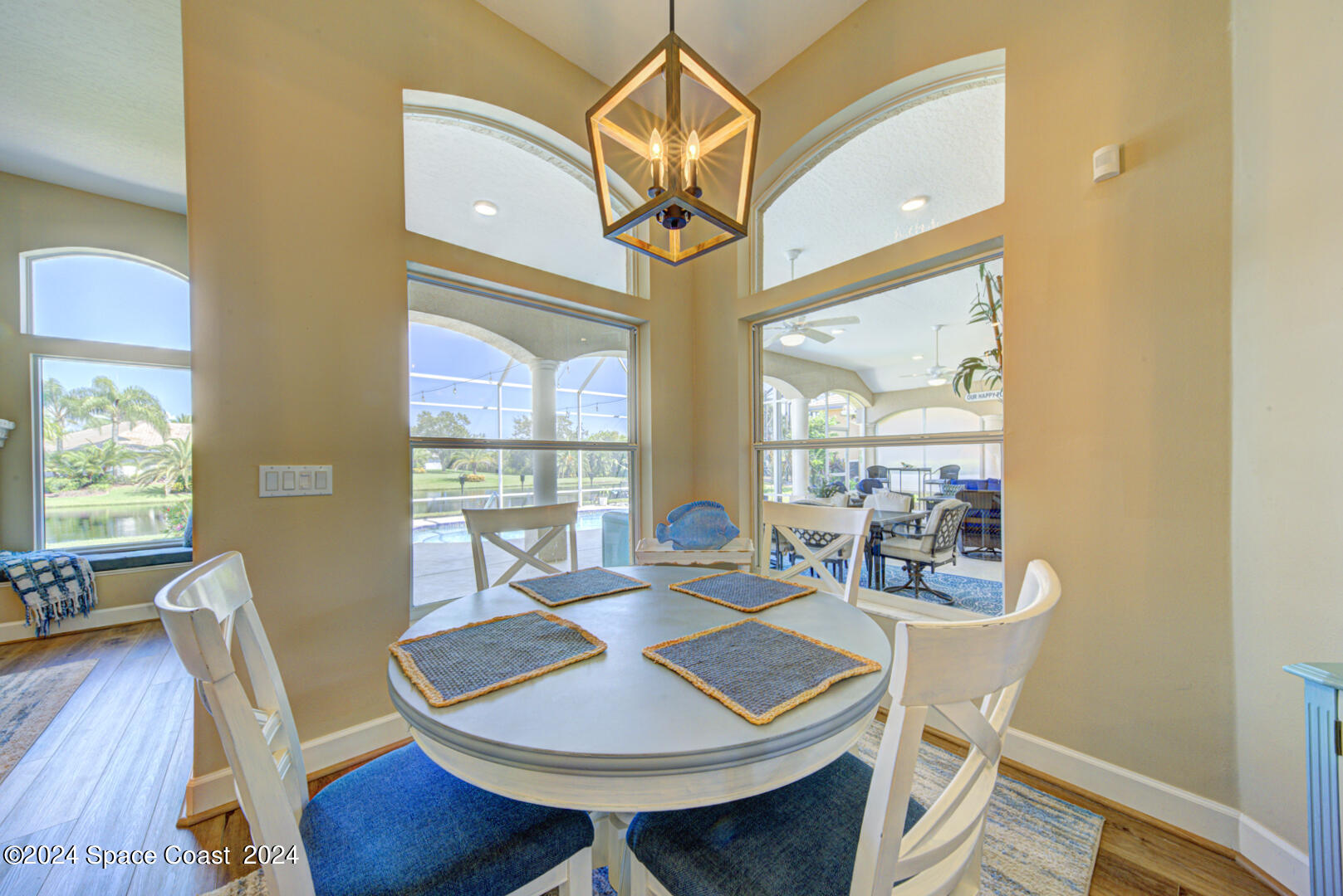4070 Stoney Point Road Melbourne, FL 32940 - Photo 27 of 75 a view of a dining room with furniture wooden floor and a chandelier
